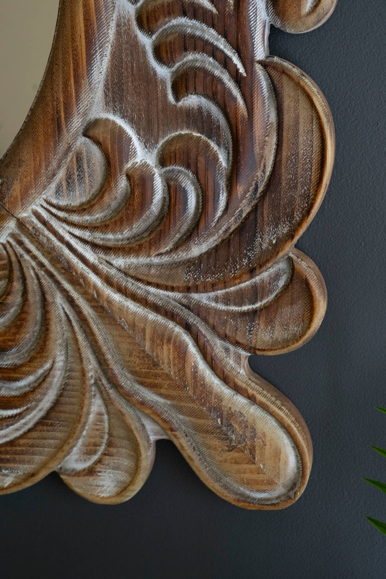Wooden carvings with intricate designs on a dark background