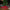 Decorated Christmas tree with a red plaid skirt and presents underneath, next to a fireplace.