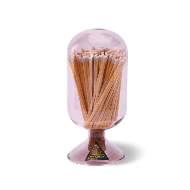 Clear glass container with wooden matches on a white background