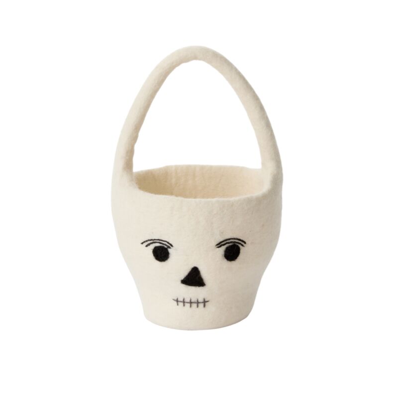 White basket with a face design on a white background