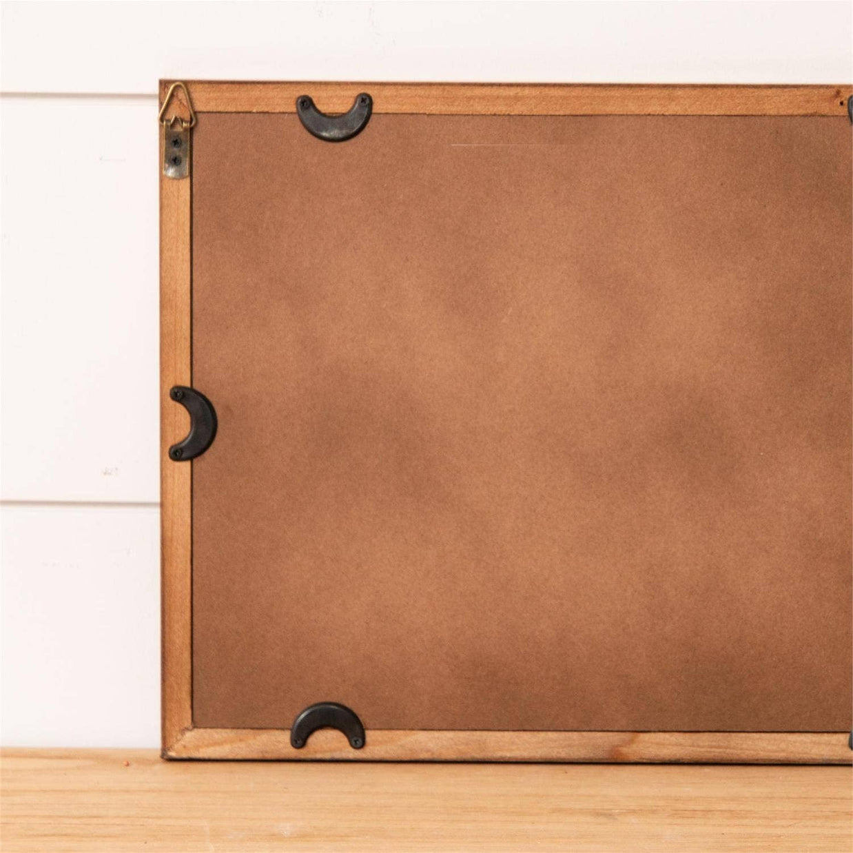 Brown backing of a framed painting. 
