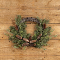 Wreath with pine cones on a wooden surface
