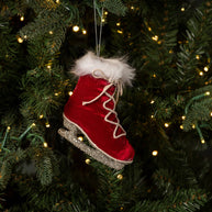 Red velvet ice skate ornament on a Christmas tree with lights