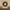 Green wreath on a wall above a wooden shelf with books and candles.