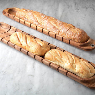 Wooden bread trays with bread on a gray marble surface