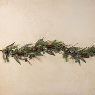 Greenery garland with pinecones on a beige background