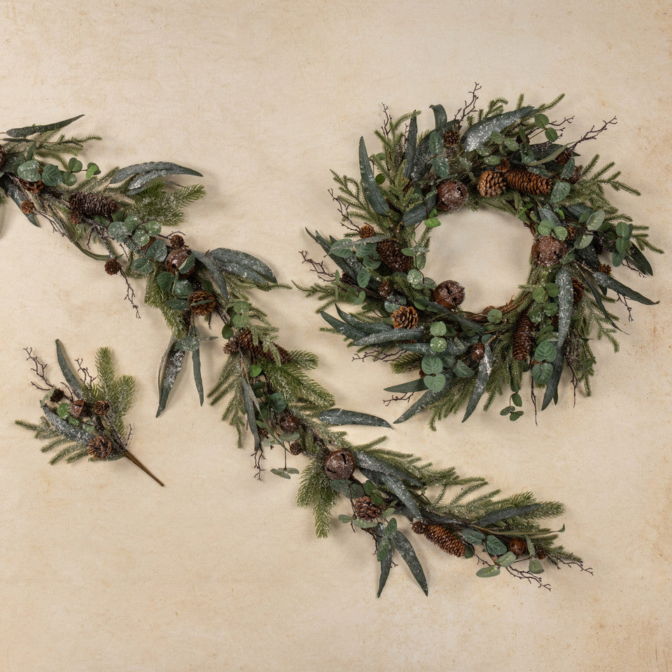 Set of greenery wreath and garland with pinecones on a beige background