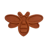Brown bee-shaped object on a white background