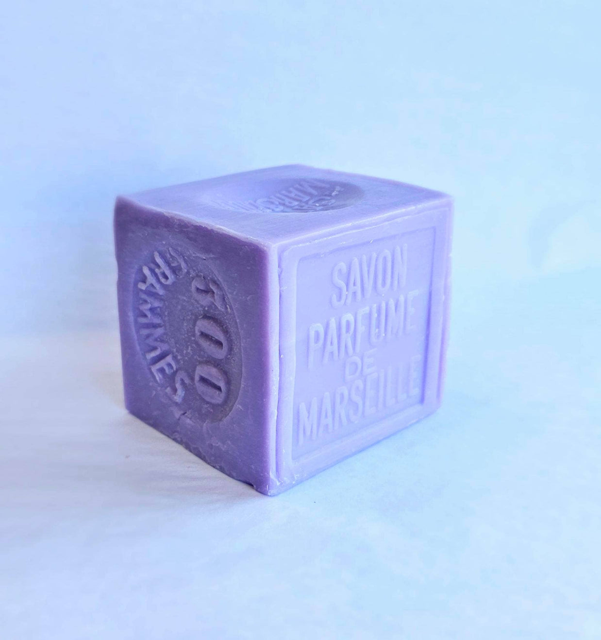 Lavender 300g Cube-shaped purple soap with text on a light blue background