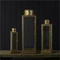 Set of three metallic lanterns on a dark background