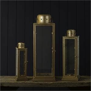 Set of three metallic lanterns on a dark background