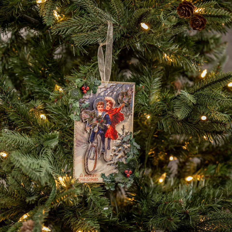 Vintage-style Christmas ornament on a decorated tree with lights.