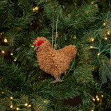 Decorative chicken ornament on a Christmas tree with lights