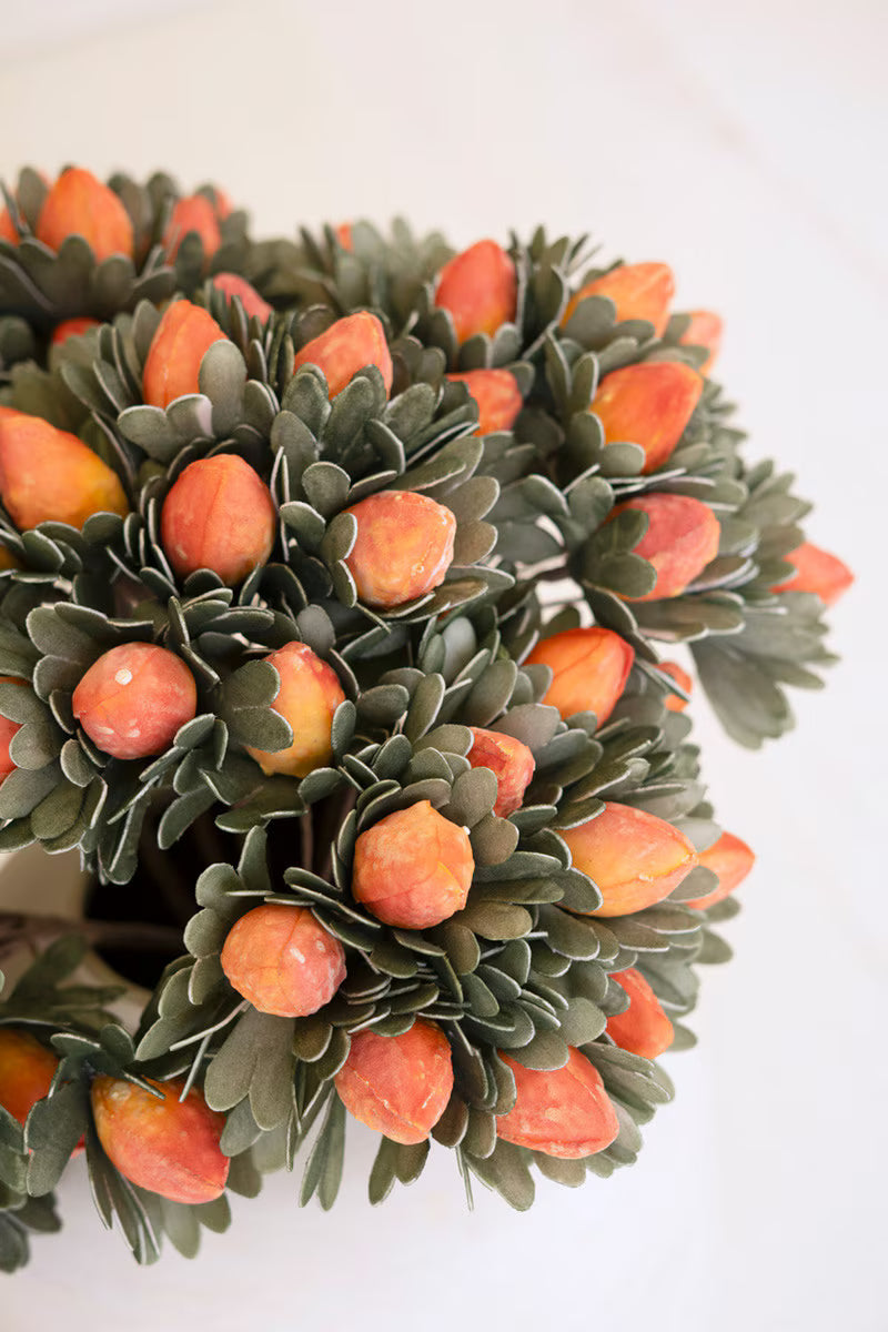 Decorative wreath with orange berries on a white background