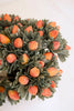 Decorative wreath with orange berries on a white background