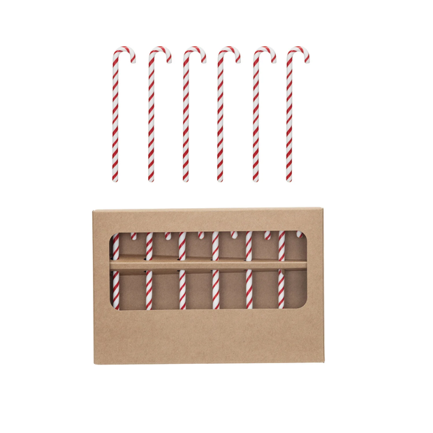Set of red and white striped straws in a cardboard box on a white background