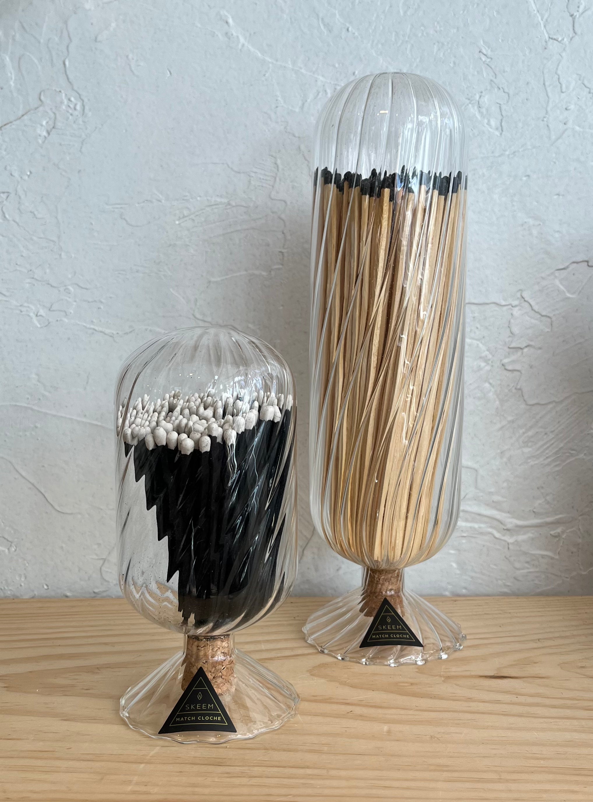 Two match cloches on a wooden surface.