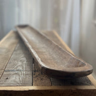 Wooden tray on a wooden surface with a blurred background