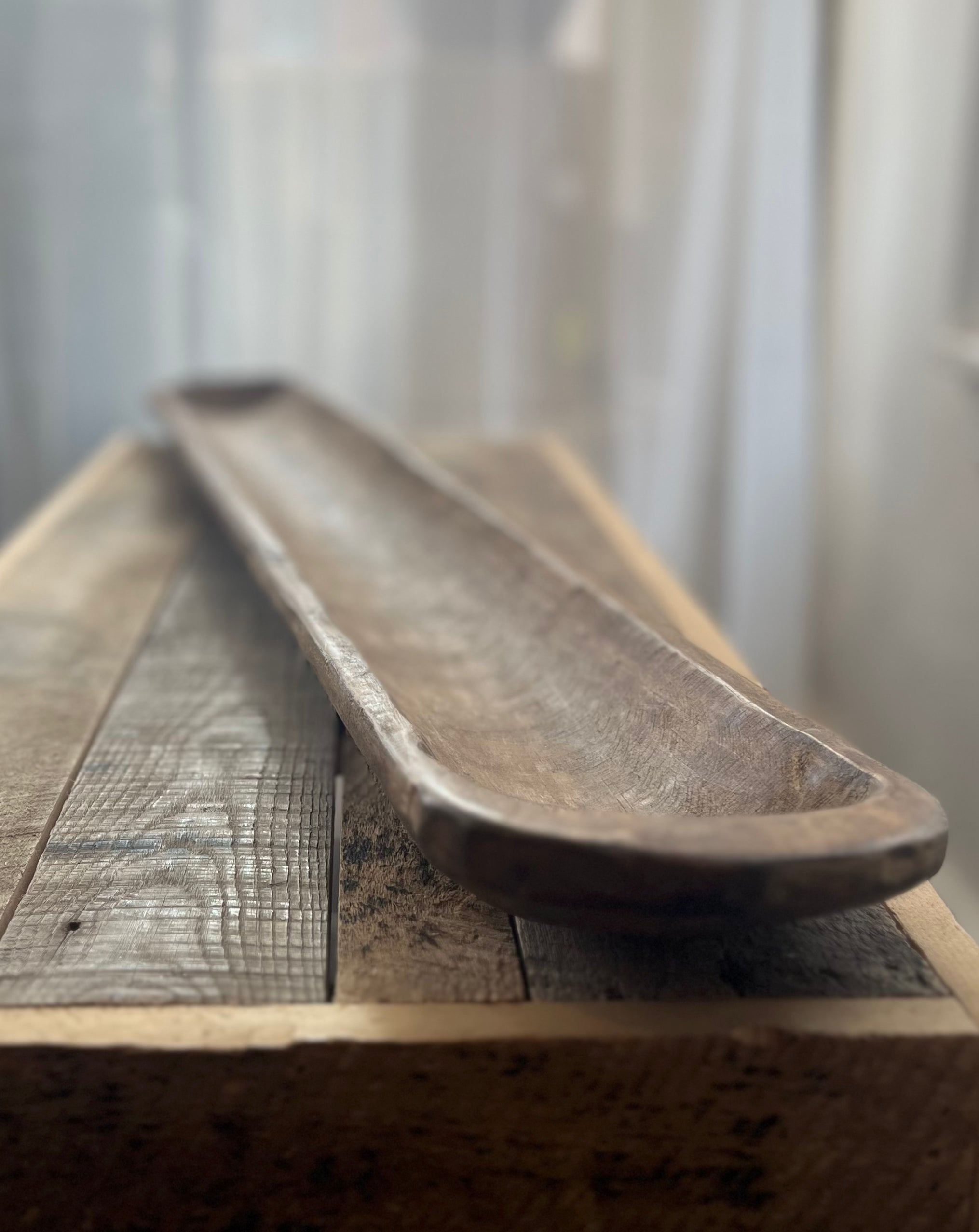 Wooden tray on a wooden surface with a blurred background