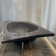Wooden bowl on a wooden surface with a blurred background