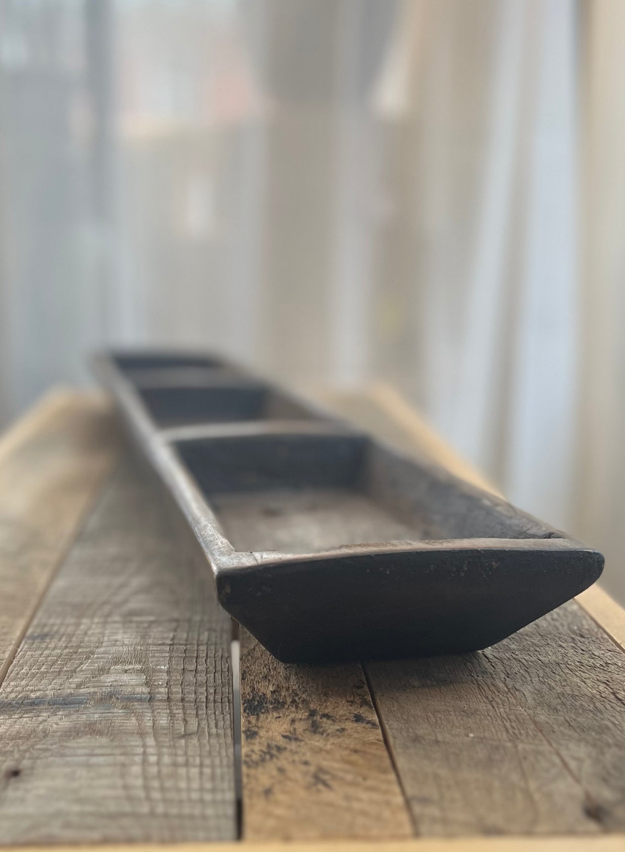 Wooden tray on a wooden surface with a blurred background