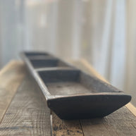 Wooden tray on a wooden surface with a blurred background