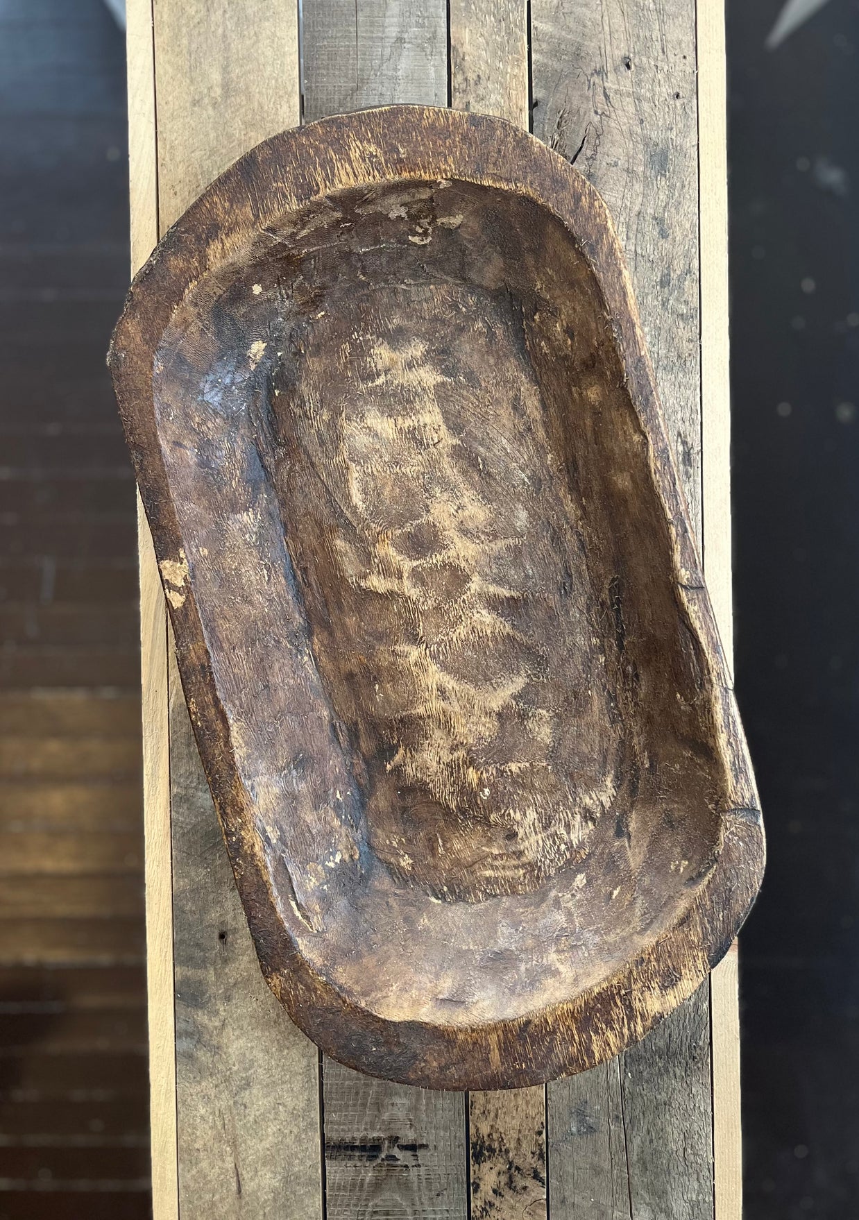 Vintage wooden mold with engraved text on a wooden surface