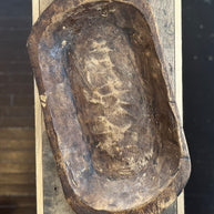 Vintage wooden mold with engraved text on a wooden surface