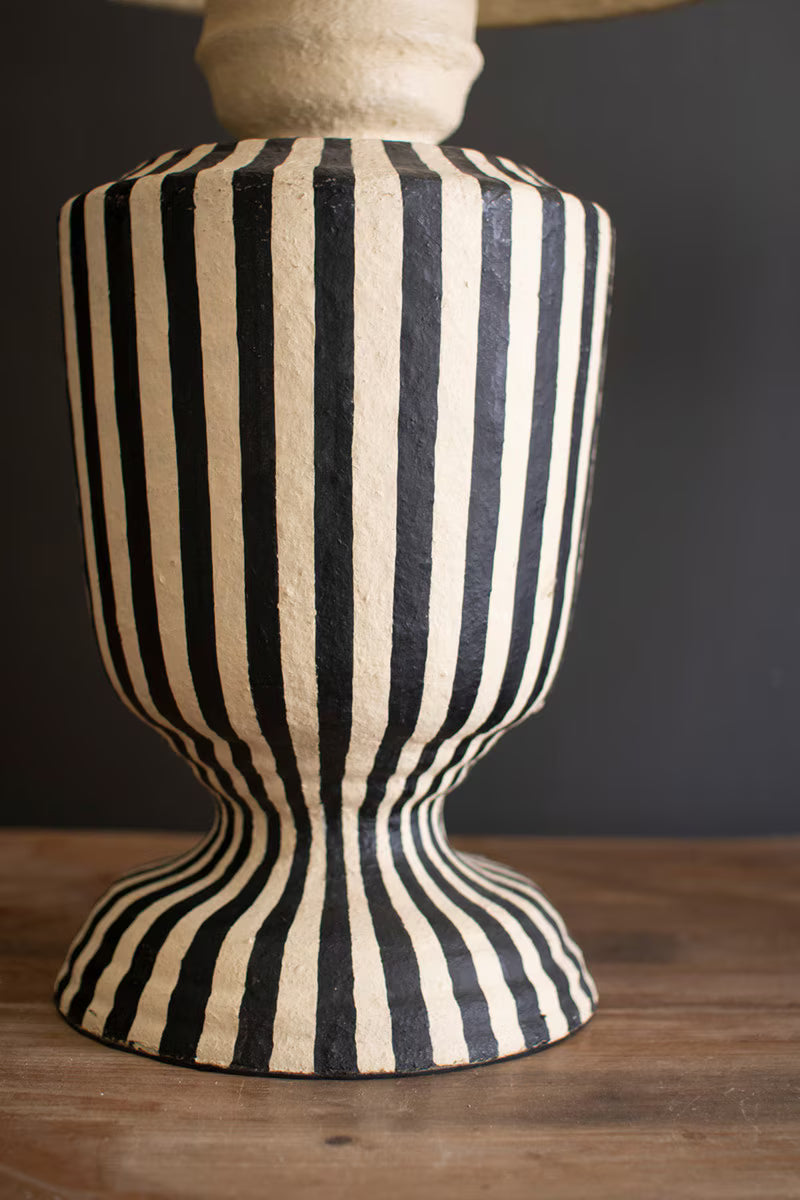 Striped lamp base with a dark background