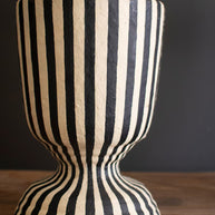Striped lamp base with a dark background