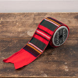 Red and black striped tie on a wooden surface