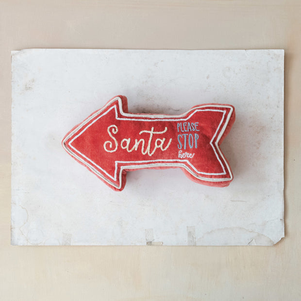 Red arrow-shaped sign with text on a white background