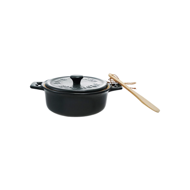 Black enameled cast iron cookware set with wooden spoon on a white background