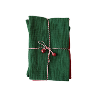 Green fabric wrapped with pink string and red heart decorations on a white background