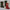 Two fabric stockings, one green and one red, on a textured surface.