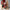 Decorative Christmas scene with a Santa figure, stockings, and a small tree.