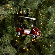 Decorative ornament of a red car with a canopy hanging on a Christmas tree.