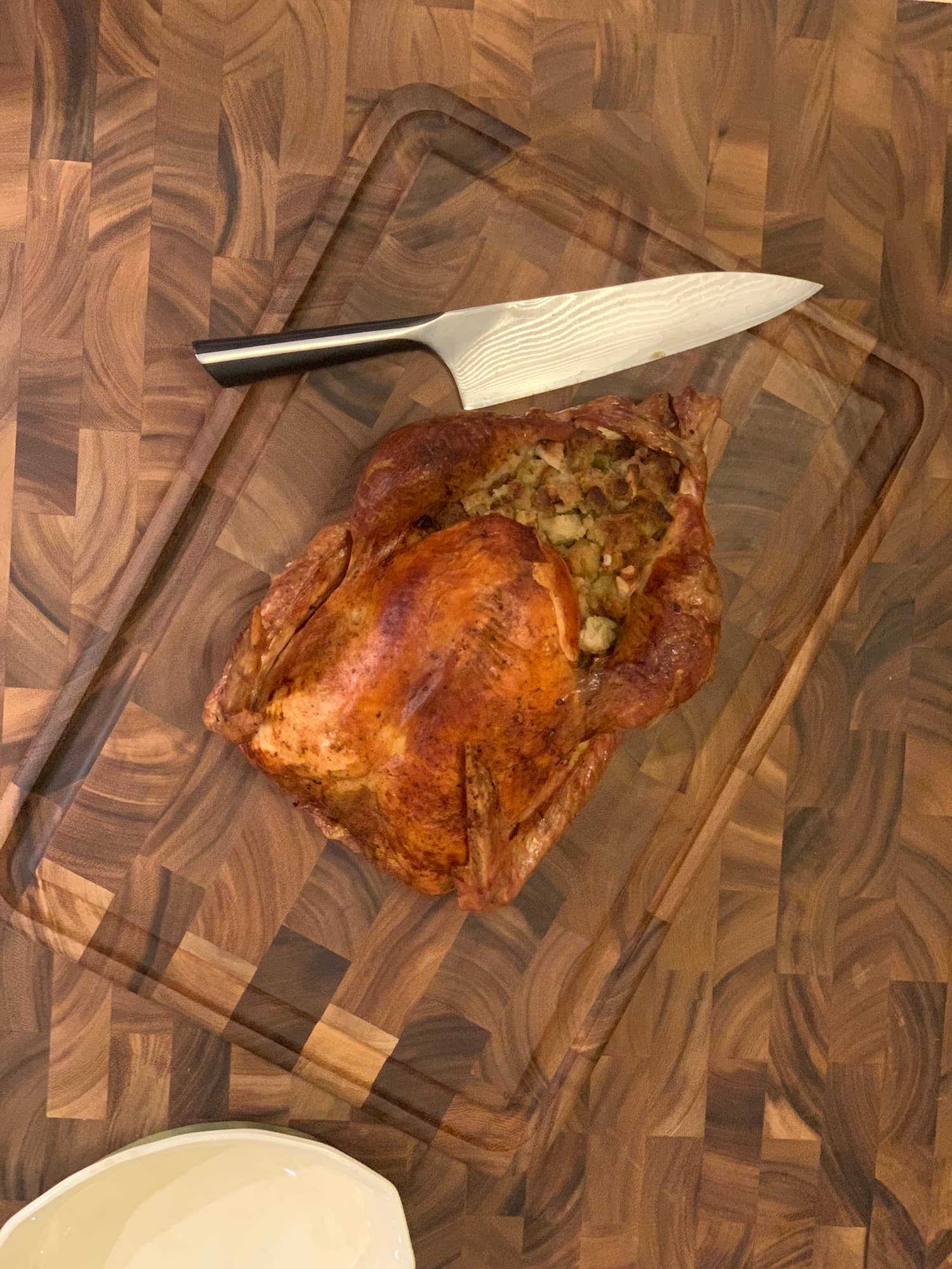 Roasted turkey on a wooden cutting board with a knife