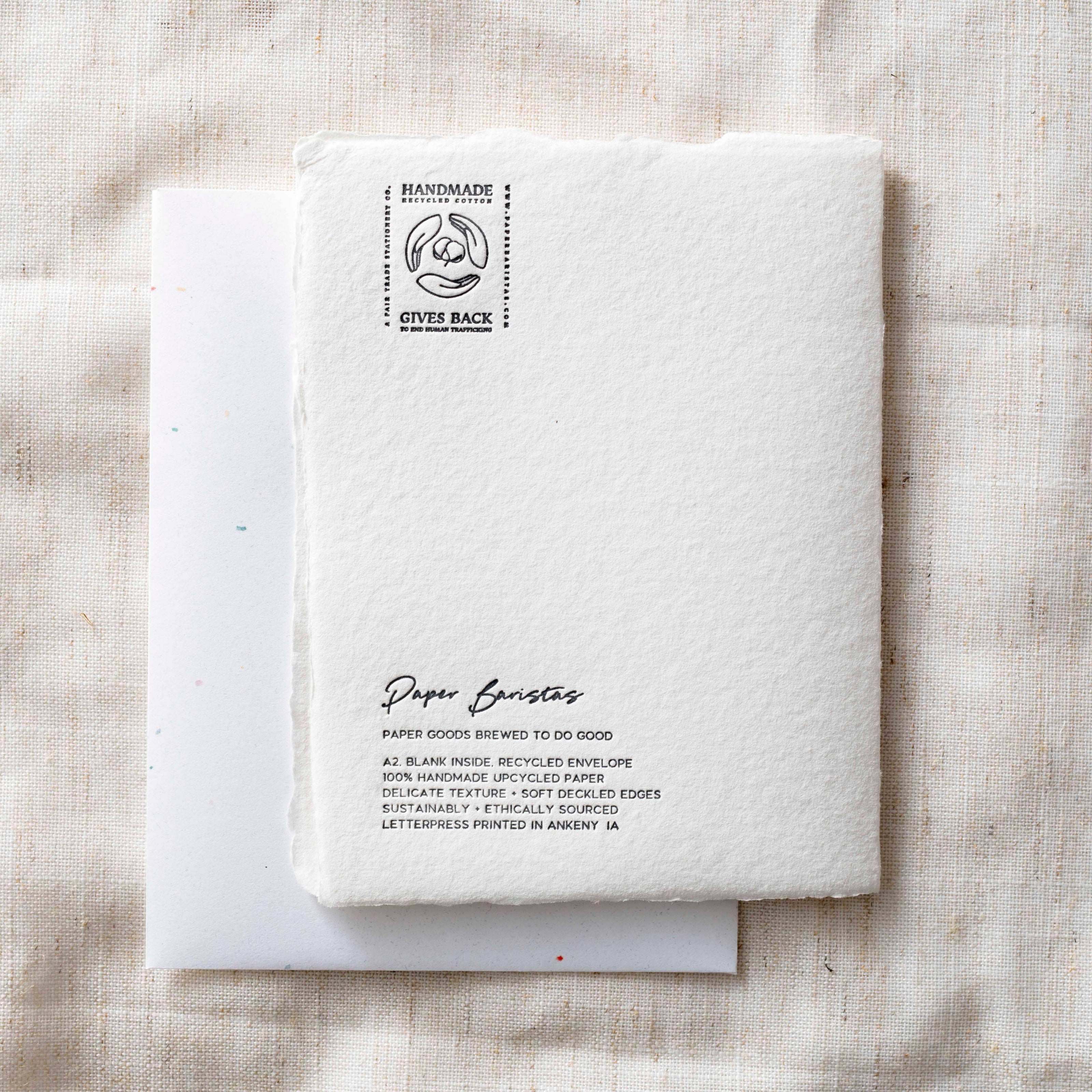 Handmade notebook with branding and text on a textured beige background