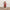 Decorative Christmas scene with a Santa figure, stockings, and a small tree.