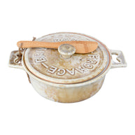 Ceramic bread loaf dish with wooden knife on a white background