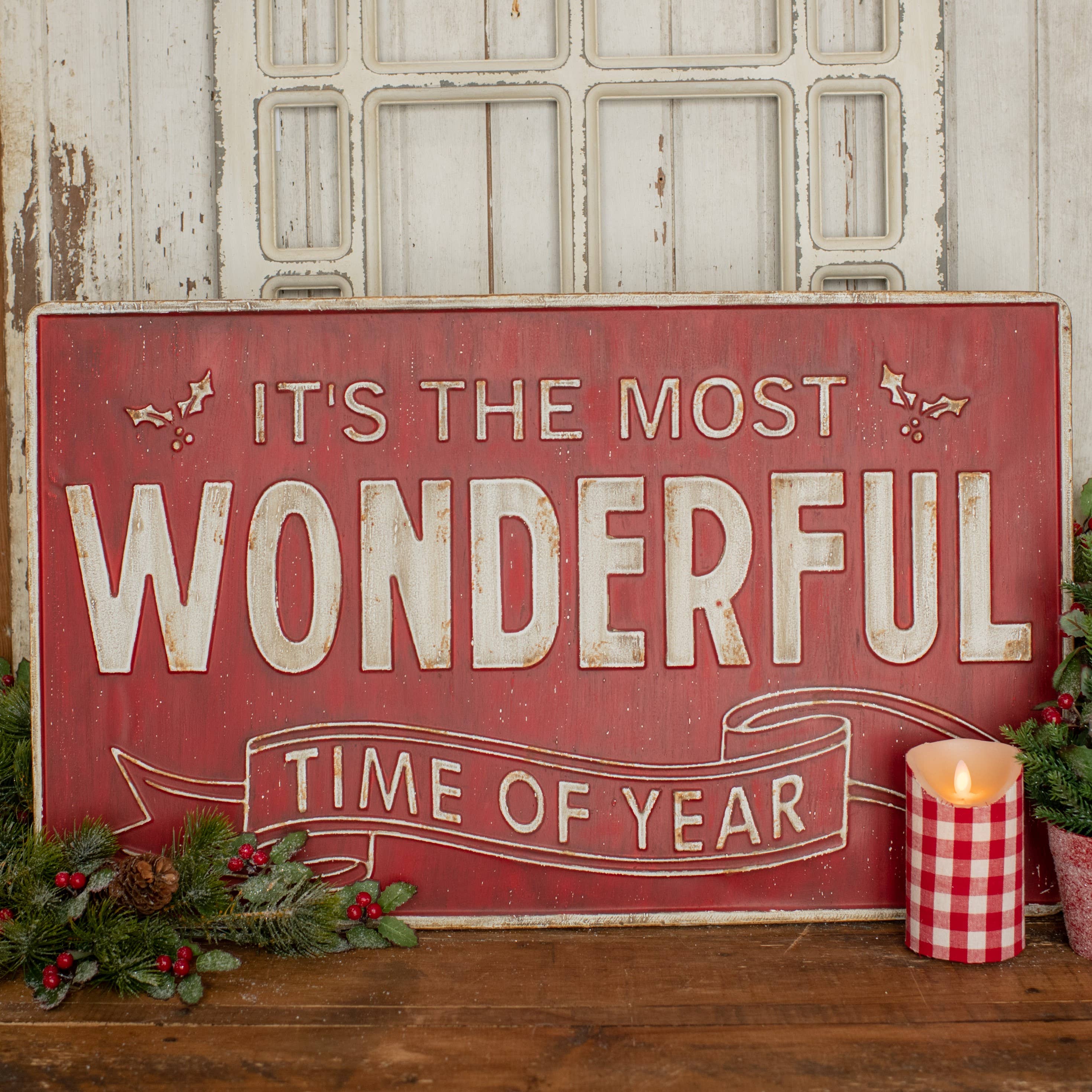 Decorative sign with 'It's the most wonderful time of year' text, surrounded by Christmas decorations.