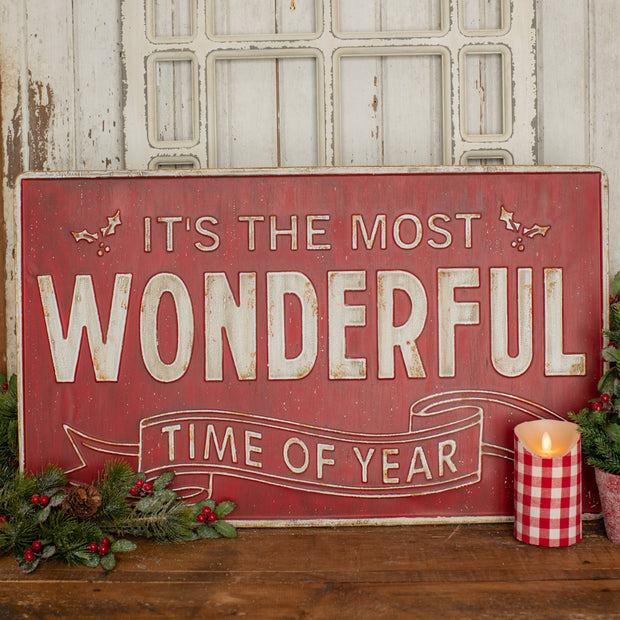 Decorative sign with 'It's the most wonderful time of year' text, surrounded by Christmas decorations.