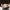 Person holding a white ceramic mug with a blurred background