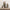 Set of four decorative Santa Claus figures on a wooden surface with a white wooden panel background.