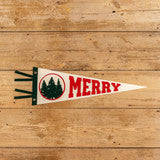 Small pennant flag with 'Merry' text on a wooden surface