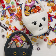 Bat and mummy baskets with assorted candy. 