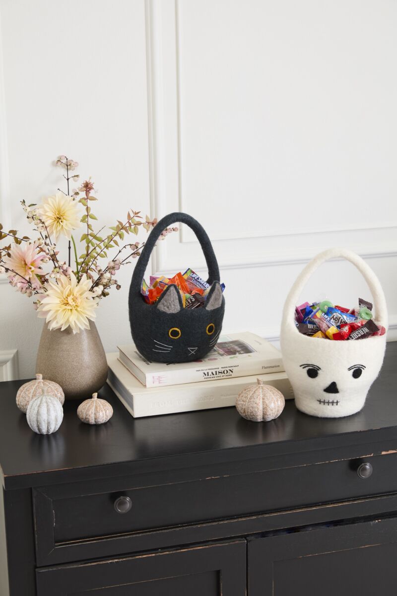 Decorative Easter basket with flowers on a black surface